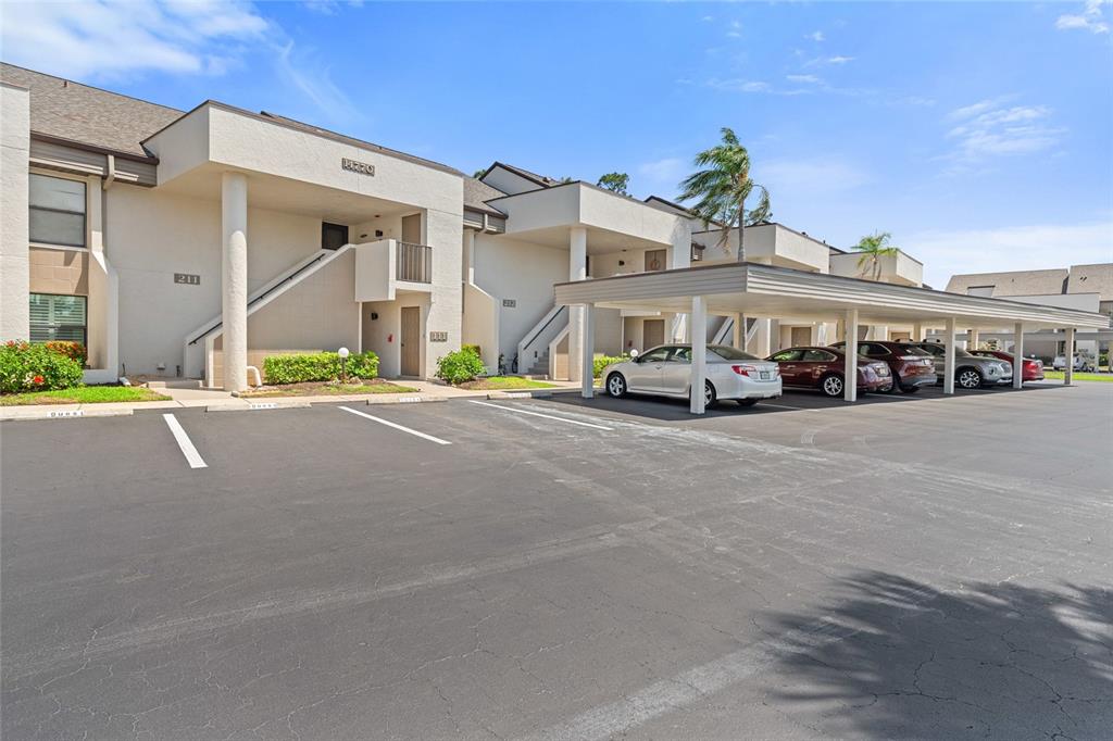 a car parked in front of white building