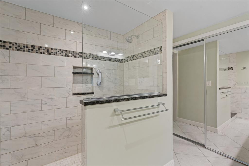 14770 Eagle Ridge Drive, Unit 112 Fort Myers, FL 33912 - Photo 14 of 32 a bathroom with a granite countertop sink mirror and shower