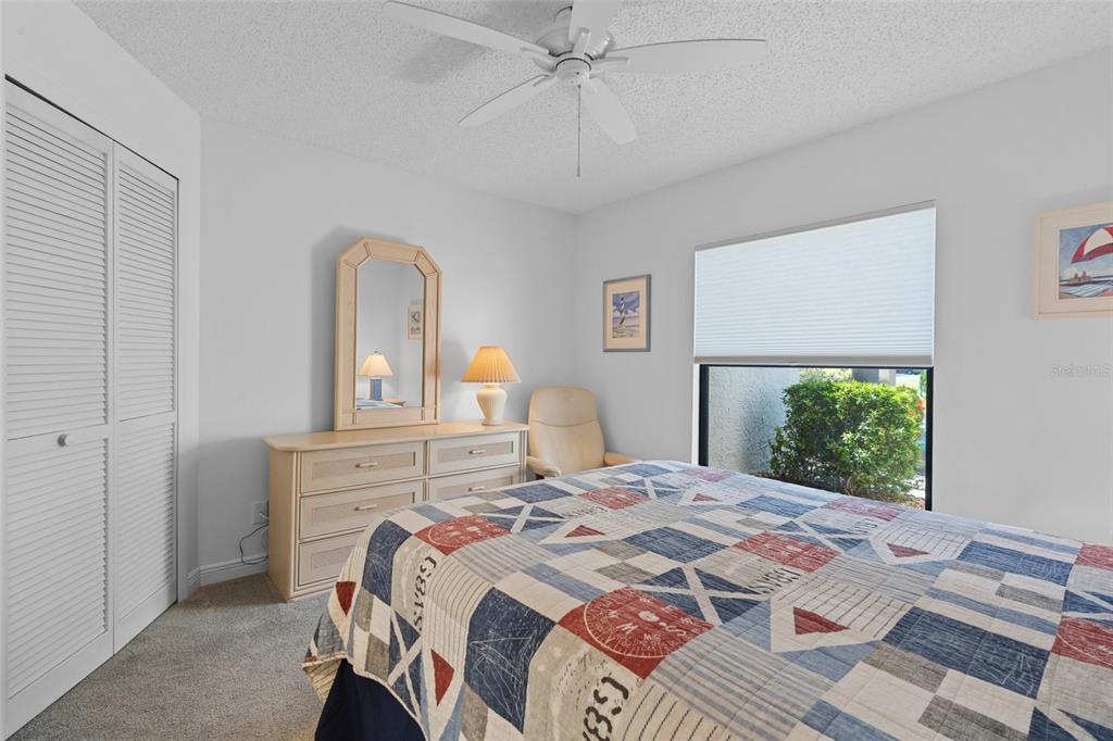 14770 Eagle Ridge Drive, Unit 112 Fort Myers, FL 33912 - Photo 16 of 32 a bedroom with a large bed and a window