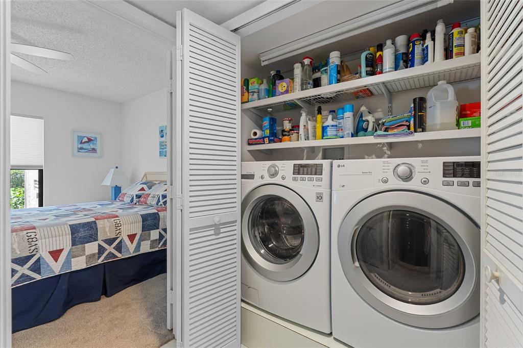 14770 Eagle Ridge Drive, Unit 112 Fort Myers, FL 33912 - Photo 18 of 32 a view of bedroom with washer and dryer