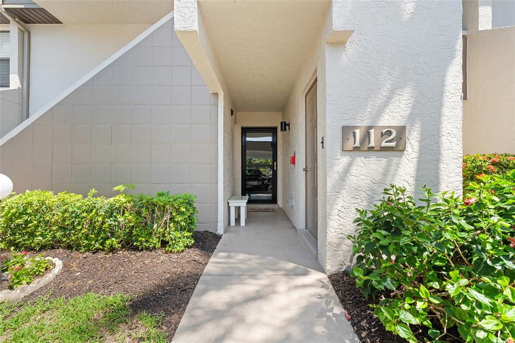 14770 Eagle Ridge Drive, Unit 112 Fort Myers, FL 33912 - Photo 2 of 32 a view of a pathway besides a house