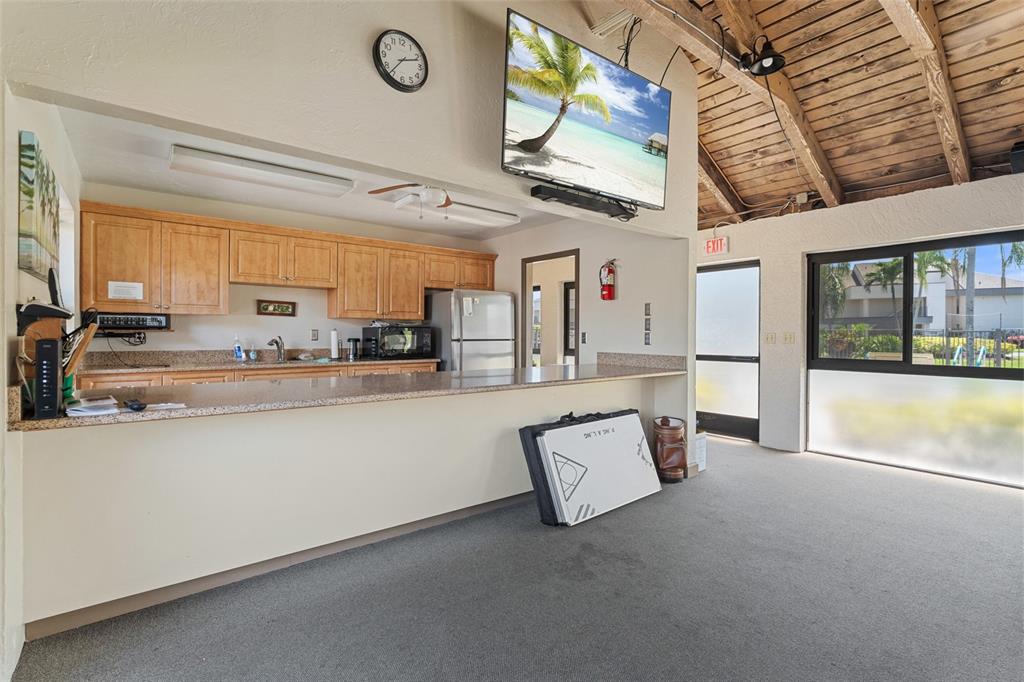 14770 Eagle Ridge Drive, Unit 112 Fort Myers, FL 33912 - Photo 25 of 32 a living room with stainless steel appliances kitchen island granite countertop furniture and a large window