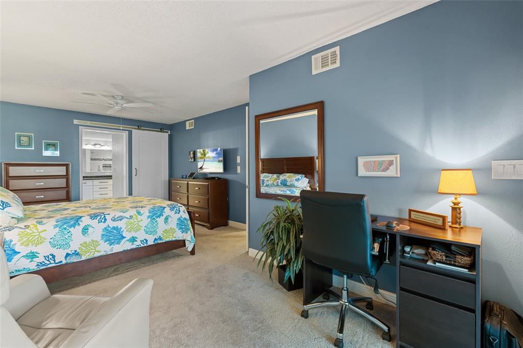 14770 Eagle Ridge Drive, Unit 112 Fort Myers, FL 33912 - Photo 9 of 32 a bedroom with a bed and furniture