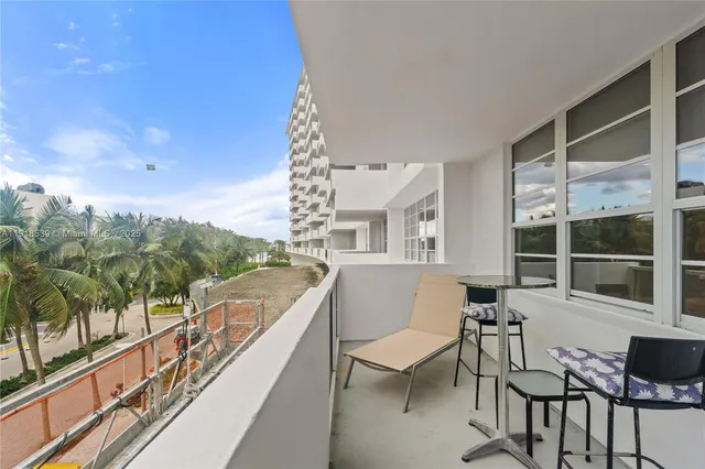 a balcony with table and chairs