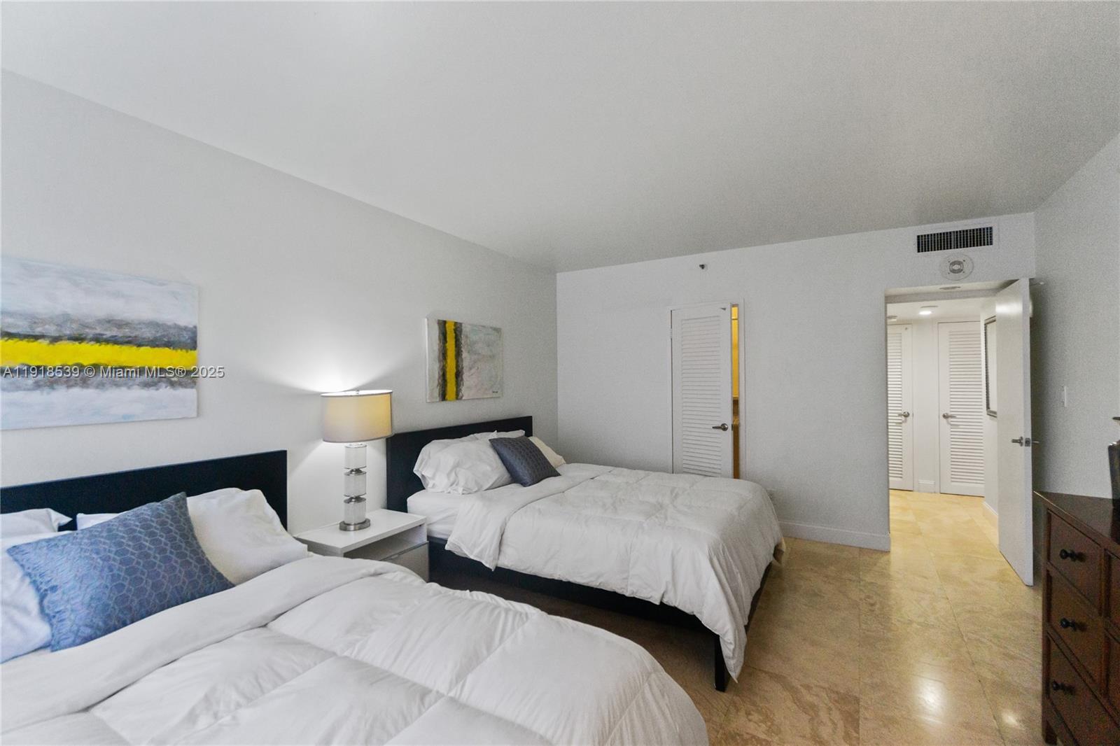 Miami Beach City Center Miami Beach, FL 33139 - Photo 11 of 15 a bedroom with a bed and a couch
