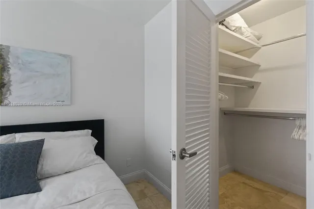 a bedroom with a bed and a walk in closet