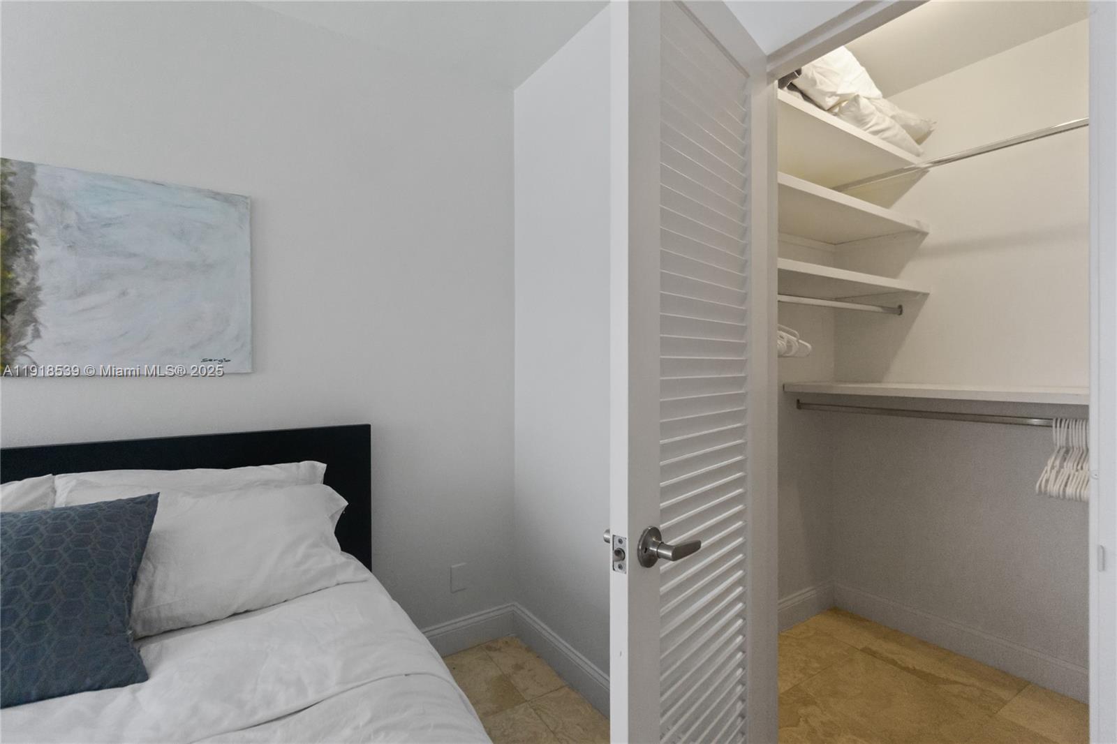 Miami Beach City Center Miami Beach, FL 33139 - Photo 12 of 15 a bedroom with a bed and a walk in closet