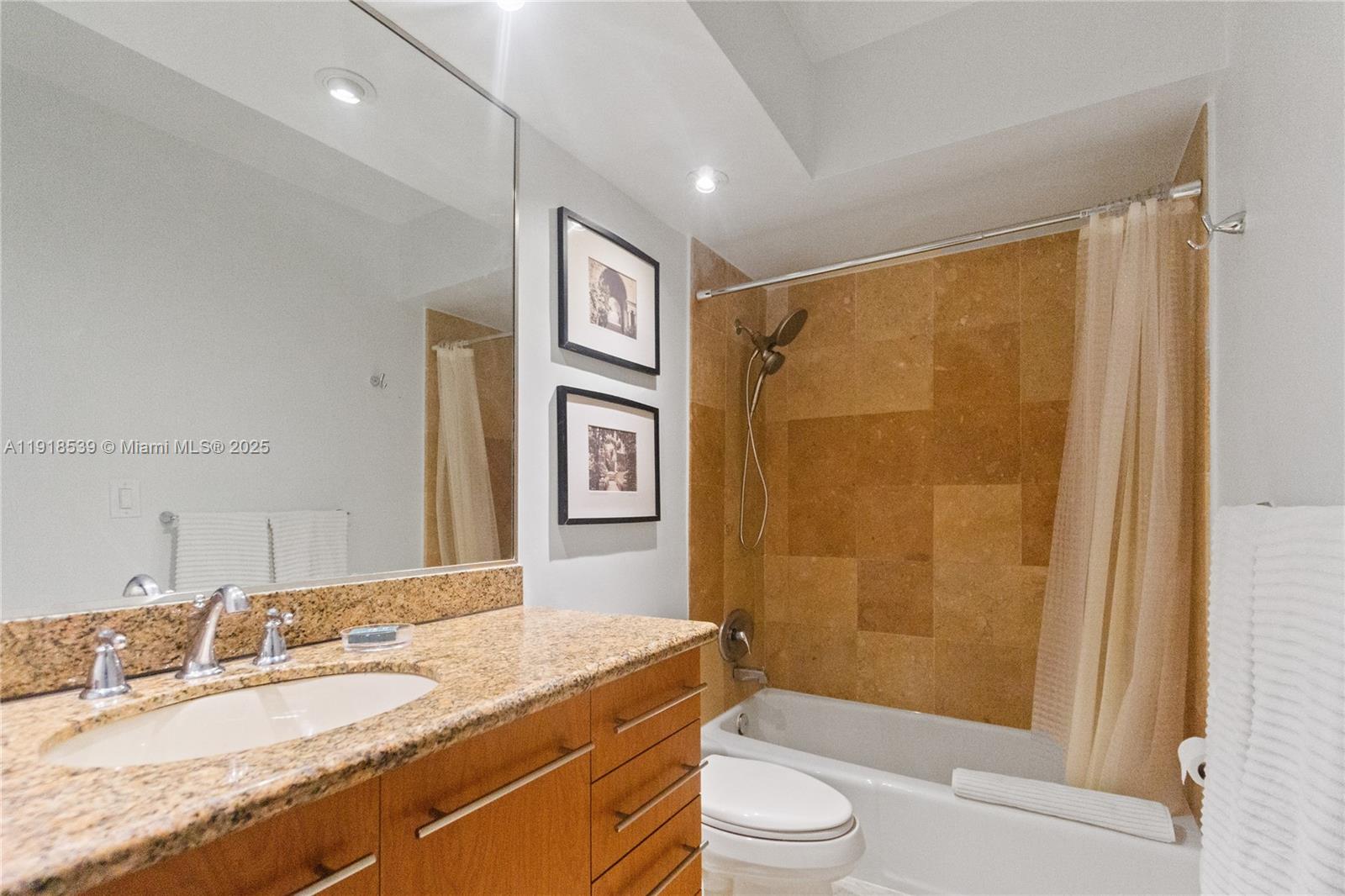 Miami Beach City Center Miami Beach, FL 33139 - Photo 13 of 15 a bathroom with a granite countertop sink toilet and shower