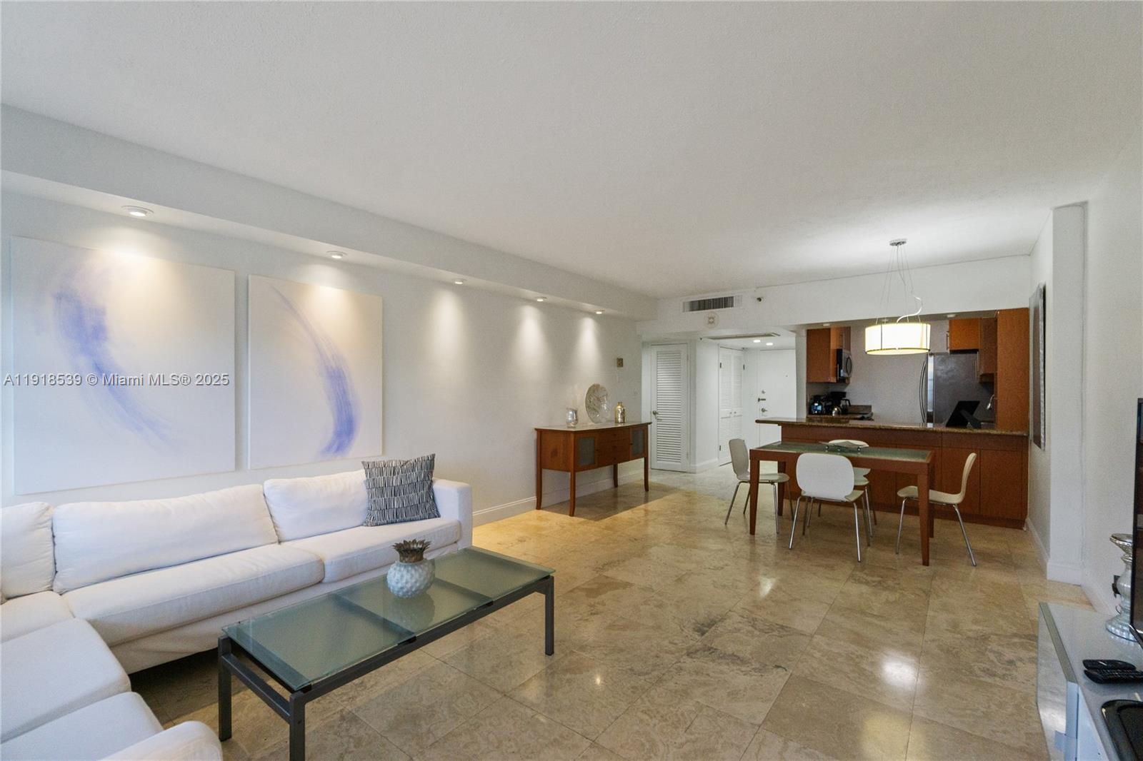 Miami Beach City Center Miami Beach, FL 33139 - Photo 4 of 15 a living room with furniture and a flat screen tv