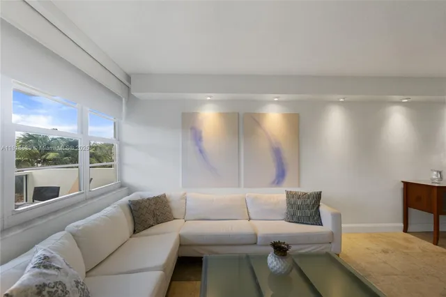 a living room with furniture and a floor to ceiling window