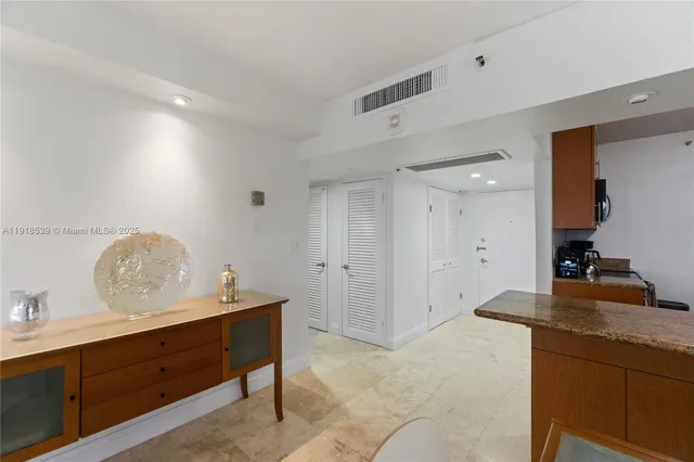 a view of room with cabinets and wooden floor