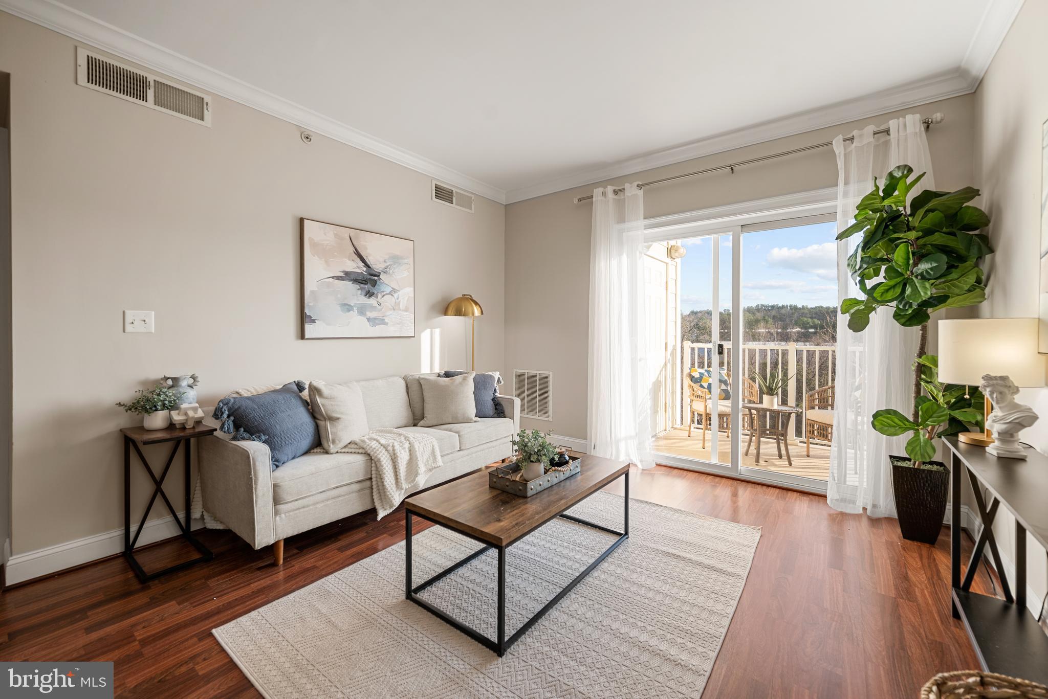 6301 Edsall Road, Unit 323 Alexandria, VA 22312 - Photo 3 of 27 a living room with furniture a potted plant and a window