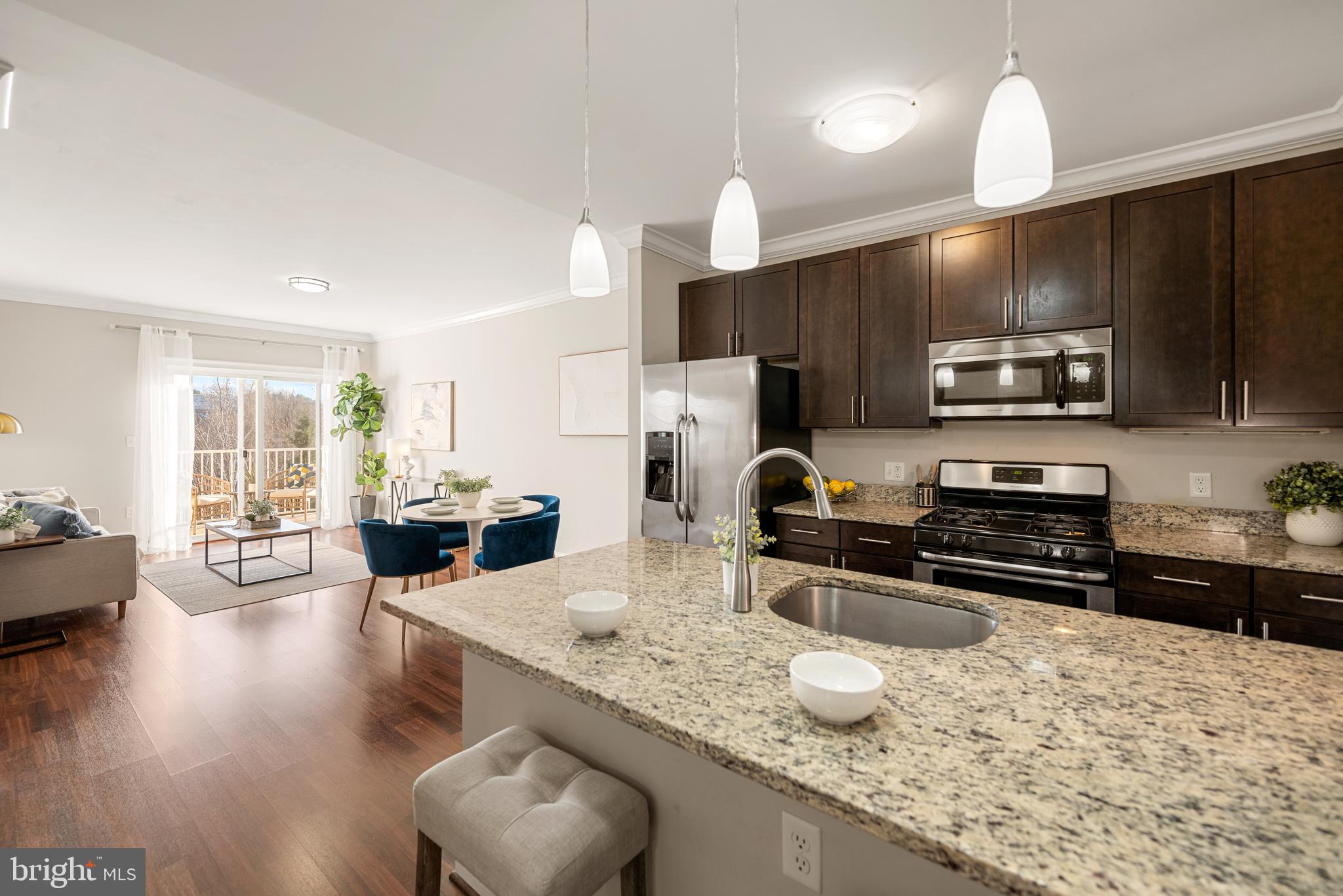 6301 Edsall Road, Unit 323 Alexandria, VA 22312 - Photo 5 of 27 a kitchen with stainless steel appliances granite countertop a sink refrigerator stove and microwave
