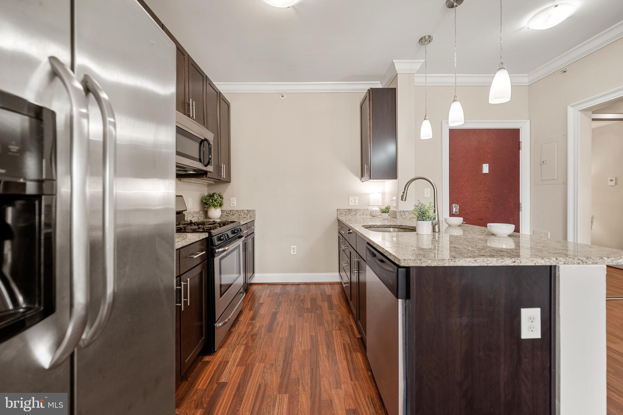 6301 Edsall Road, Unit 323 Alexandria, VA 22312 - Photo 6 of 27 a kitchen with stainless steel appliances granite countertop a sink and refrigerator