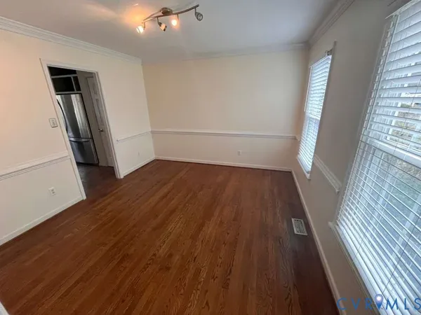 wooden floor in an empty room with a fireplace