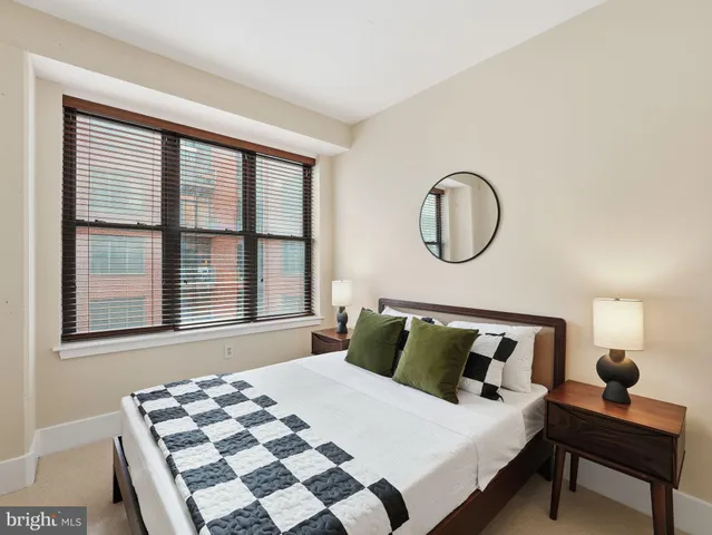 a bedroom with a bed and a window