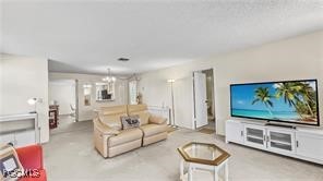 7074 Nantucket Circle, Unit 5 North Fort Myers, FL 33917 - Photo 13 of 13 a living room with furniture and a flat screen tv