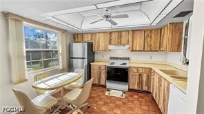 7074 Nantucket Circle, Unit 5 North Fort Myers, FL 33917 - Photo 5 of 13 a kitchen with stainless steel appliances granite countertop a sink stove and refrigerator