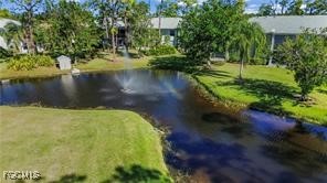 7074 Nantucket Circle, Unit 5 North Fort Myers, FL 33917 - Photo 10 of 13 a view of a lake with a yard