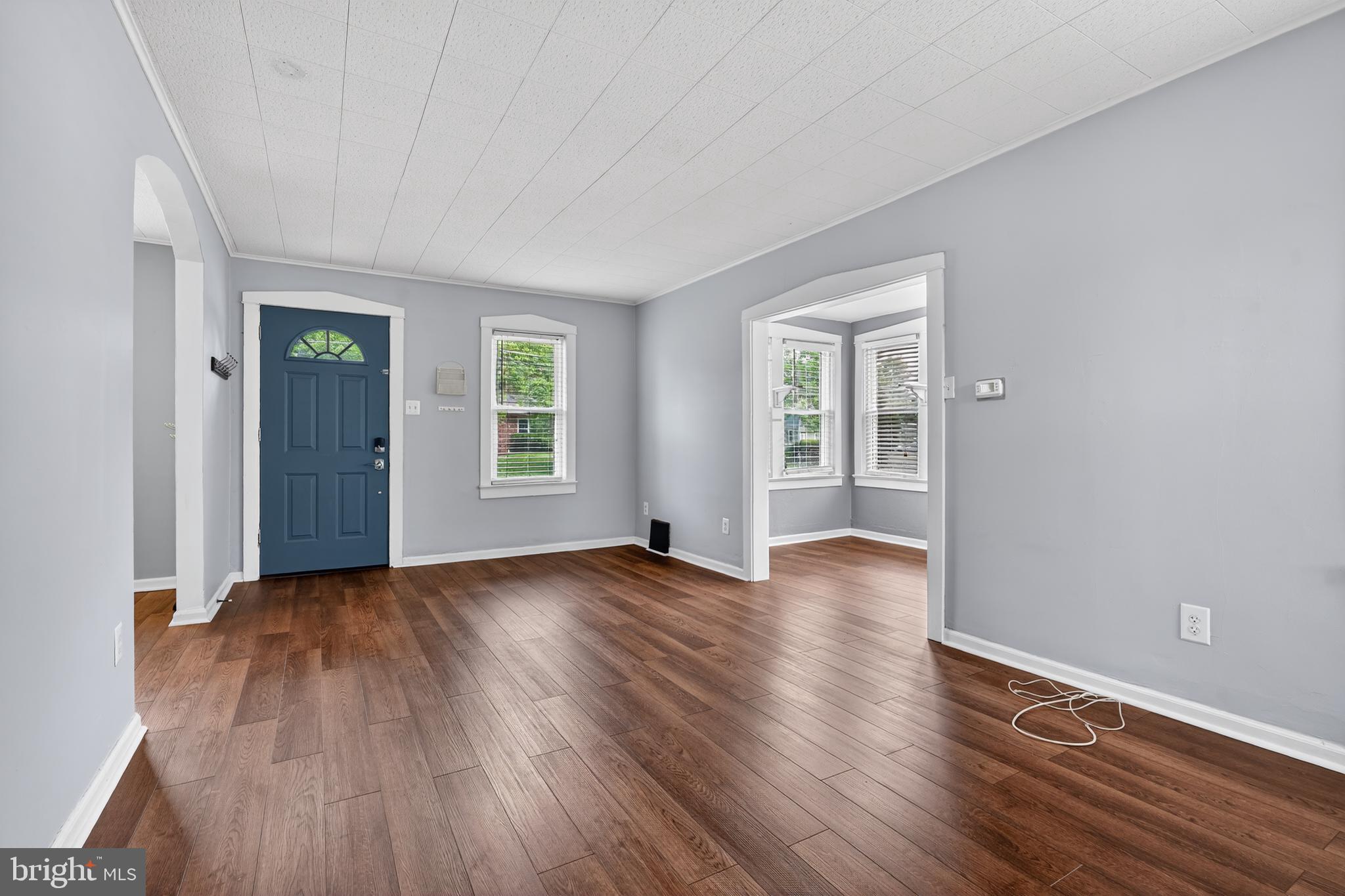 106 Ford Street Voorhees, NJ 08043 - Photo 4 of 36 an empty room with wooden floor and windows