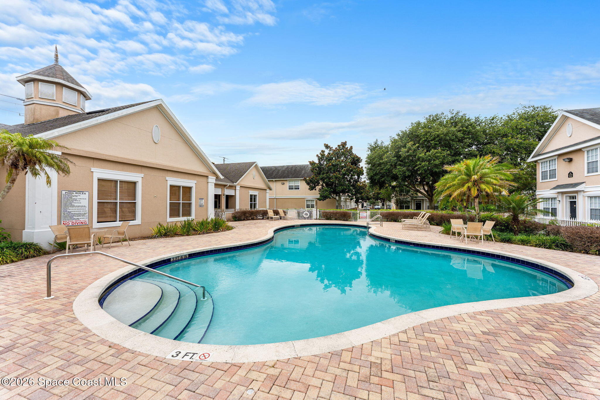110 Turpial Way, Unit 106 Melbourne, FL 32901 - Photo 2 of 50 a view of a house with swimming pool and sitting area