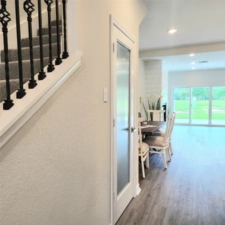 a very nice looking room with wooden floor and furniture