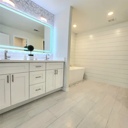 a bathroom with a granite countertop sink a toilet and a mirror
