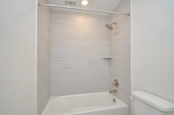 a bathroom with a shower and a toilet