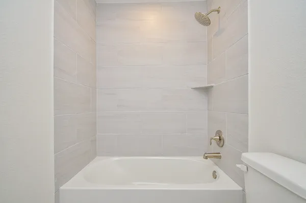 a bathroom with a bathtub and toilet