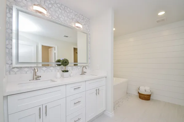 a bathroom with a double vanity sink a mirror and a