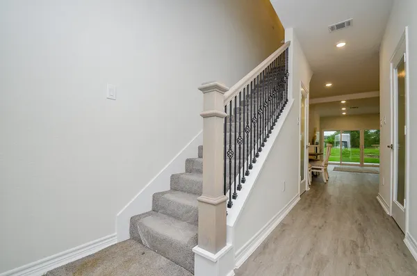a view of entryway and hall with wooden floor
