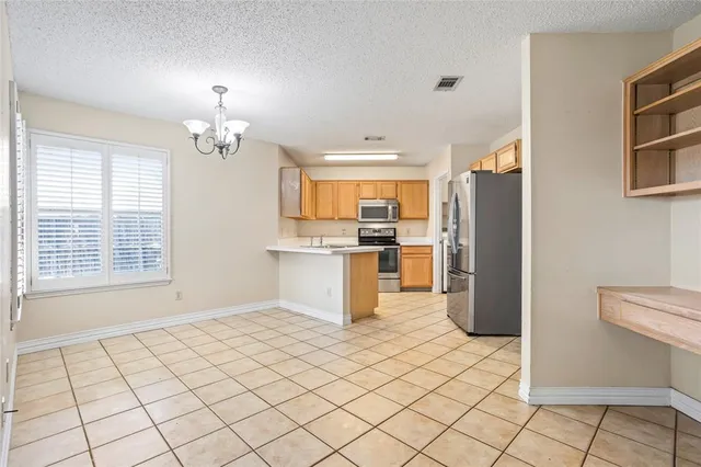 a view of kitchen with furniture and refrigerator