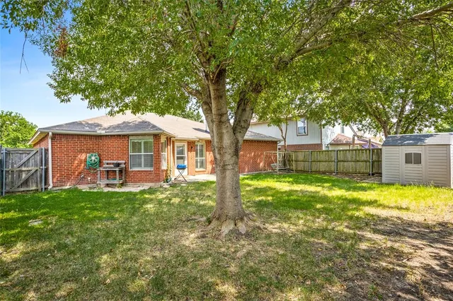 a backyard of a house with table and chairs