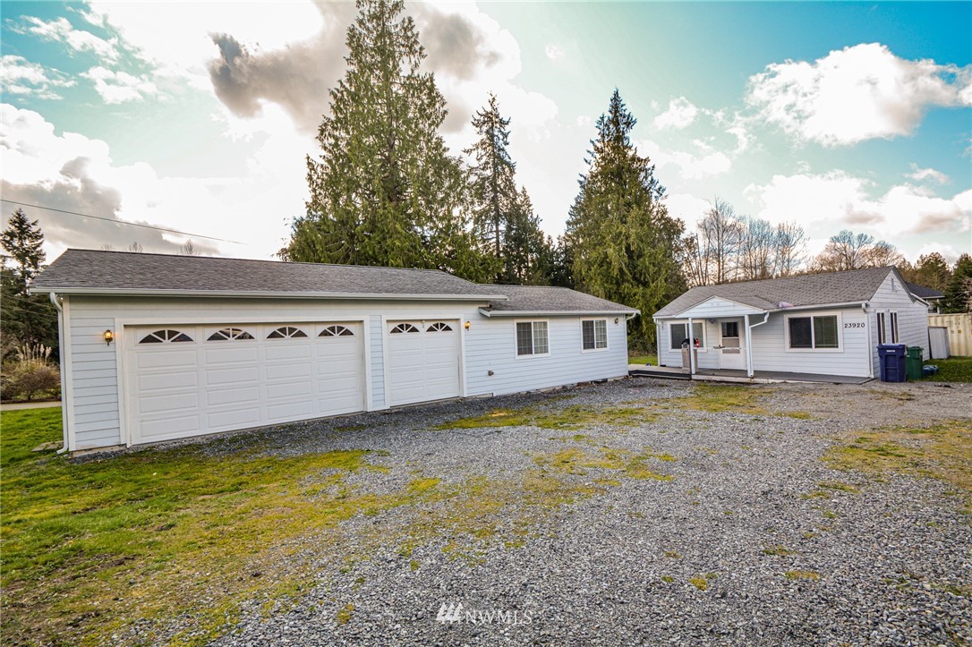 23920 Brier Road Brier, WA 98036 - Photo 1 of 23 a front view of a house with a garden and trees