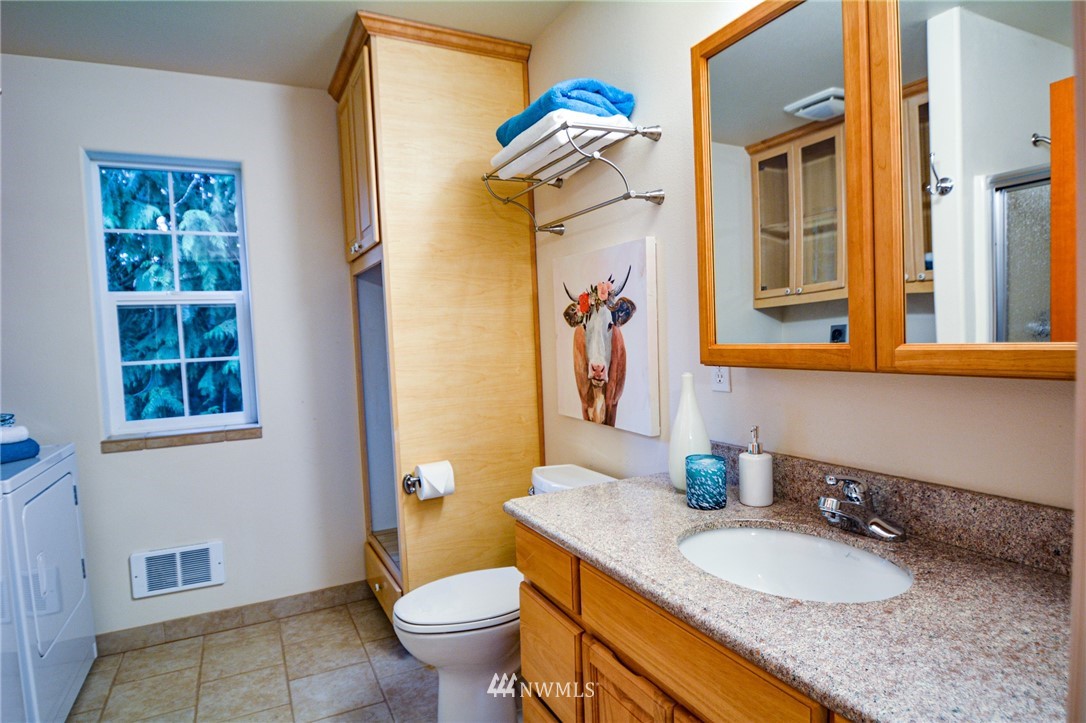 23920 Brier Road Brier, WA 98036 - Photo 17 of 23 a bathroom with a granite countertop sink and a mirror