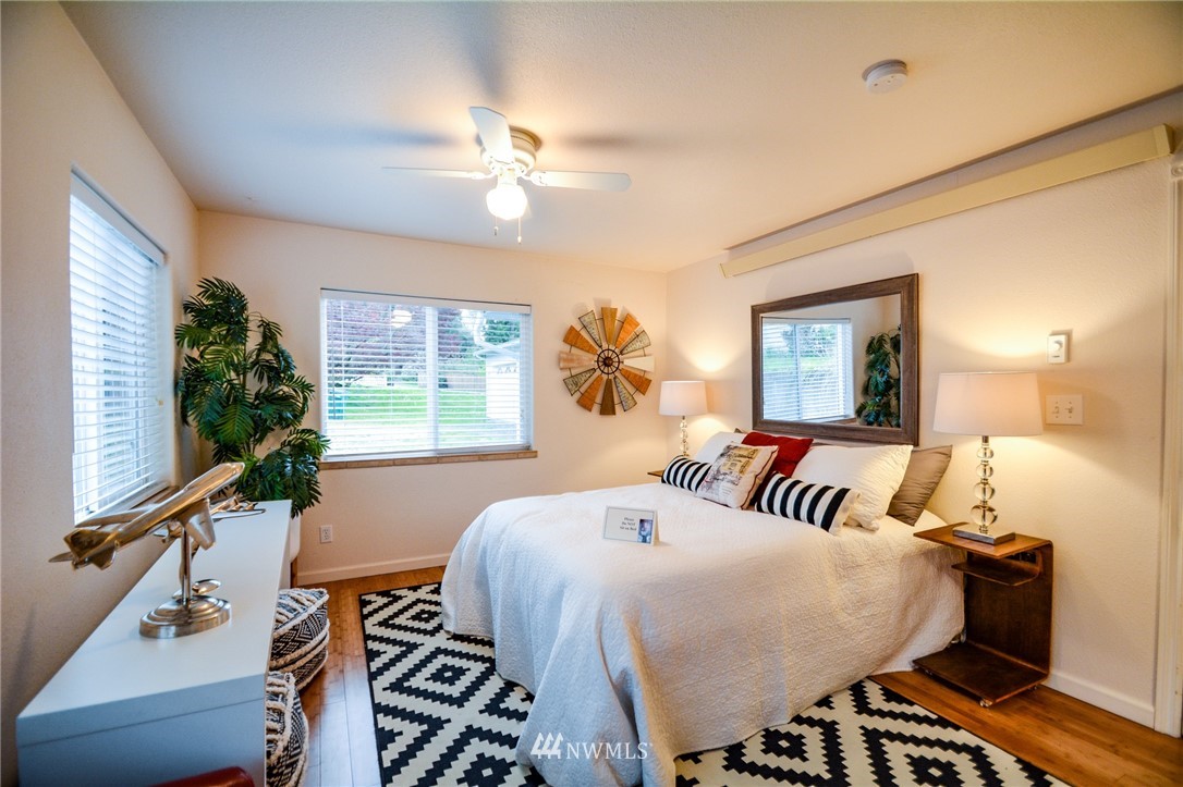 23920 Brier Road Brier, WA 98036 - Photo 5 of 23 a bed room with a bed and a chandelier