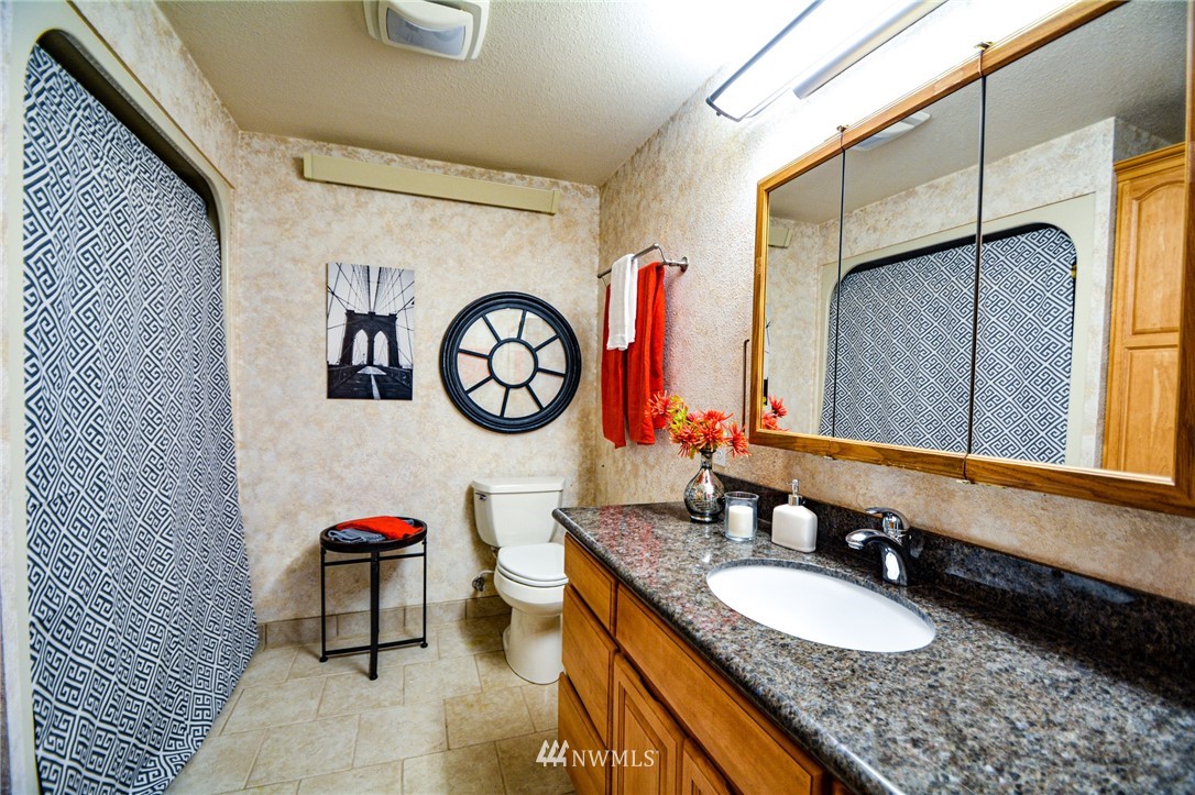 23920 Brier Road Brier, WA 98036 - Photo 10 of 23 a bathroom with a granite countertop sink and a mirror