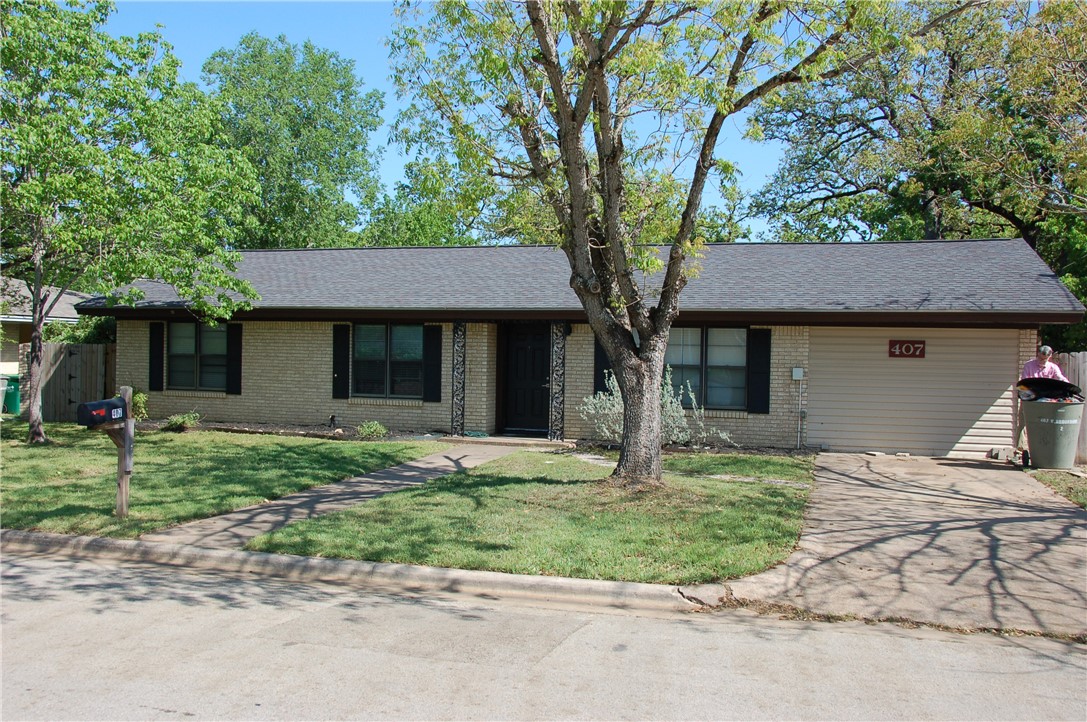 a house that has a tree in front of it