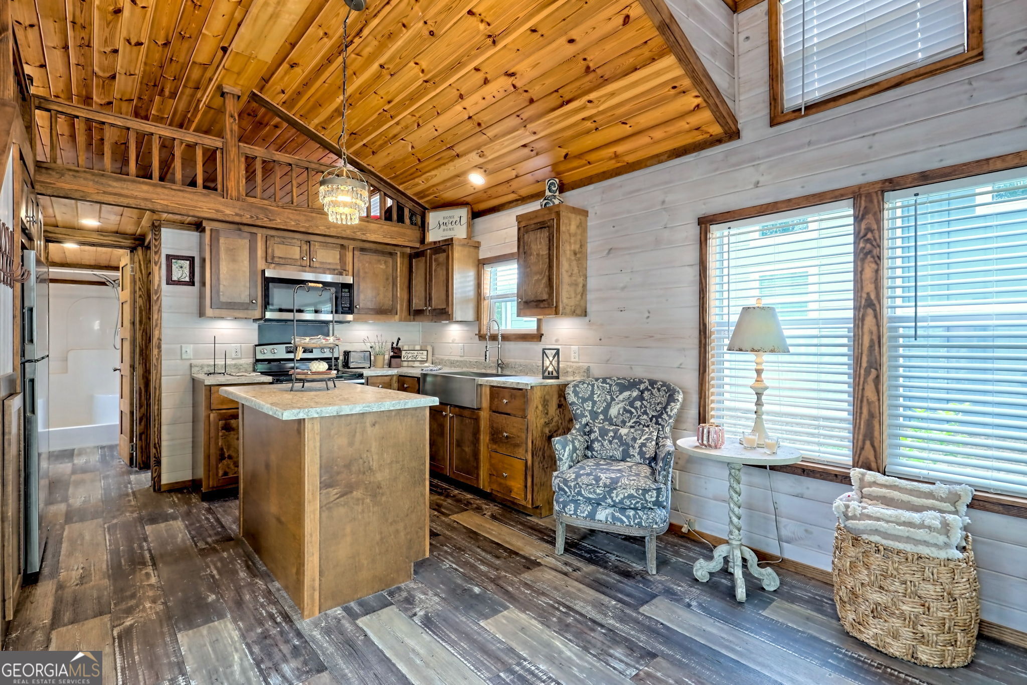 4960 Laurel Lodge Road Clarkesville, GA 30523 - Photo 6 of 29 a kitchen with stainless steel appliances granite countertop a stove a refrigerator a sink dishwasher with a dining table and chairs with wooden floor