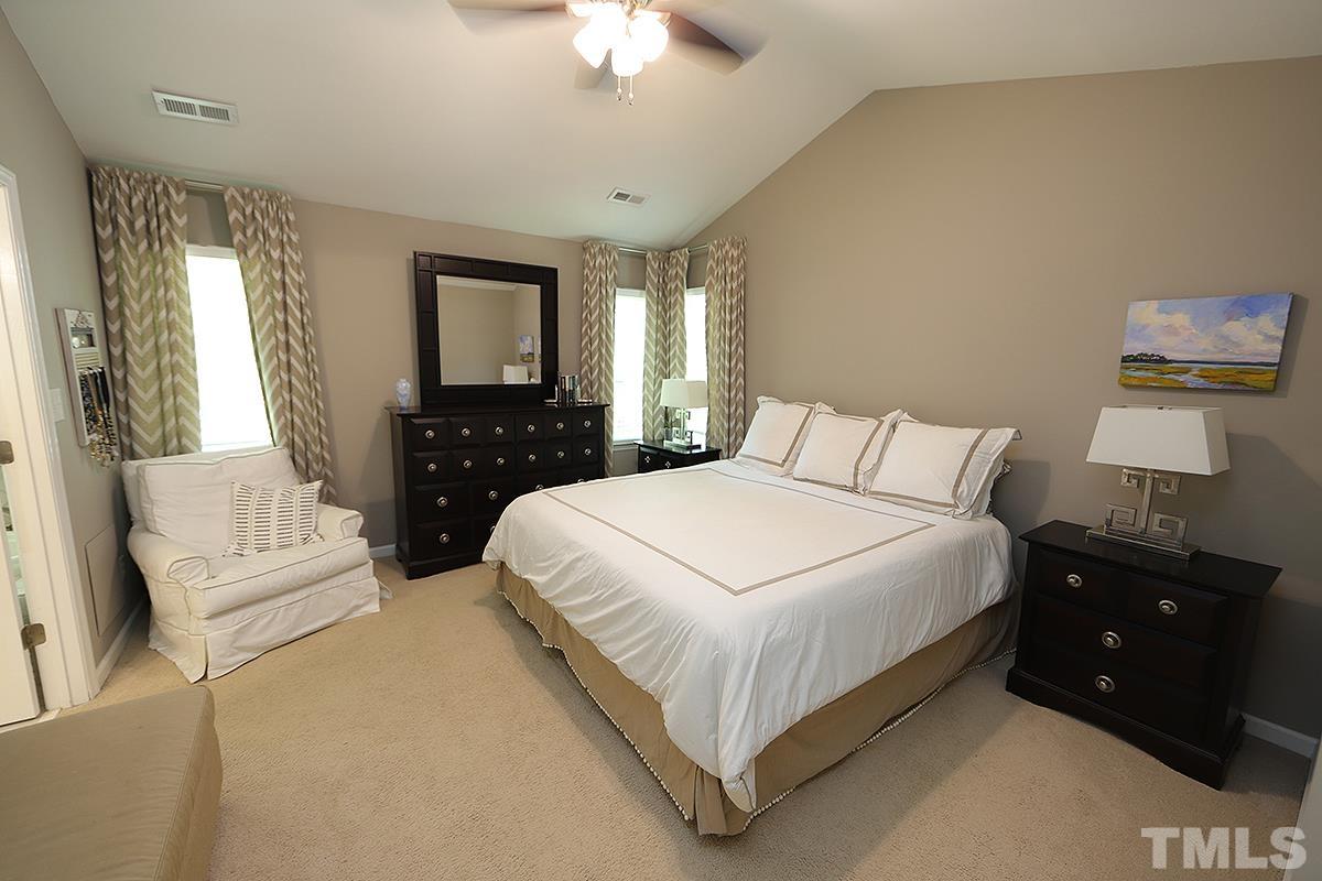 5152 Fairmead Circle Raleigh, NC 27613 - Photo 12 of 25 a bedroom with a bed and a lamp