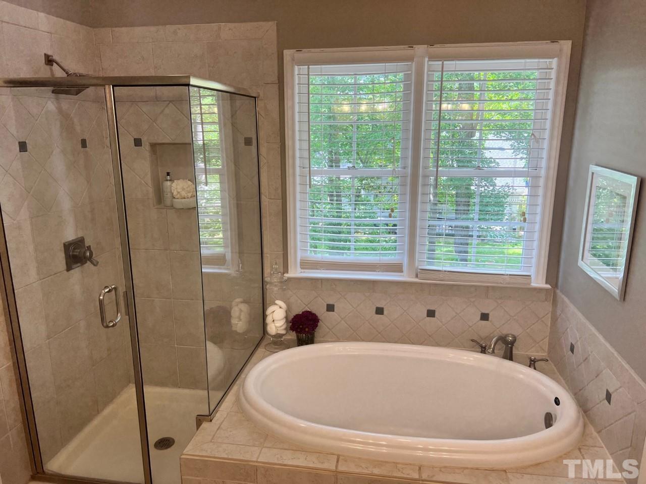 5152 Fairmead Circle Raleigh, NC 27613 - Photo 14 of 25 a white bath tub sitting next to a shower