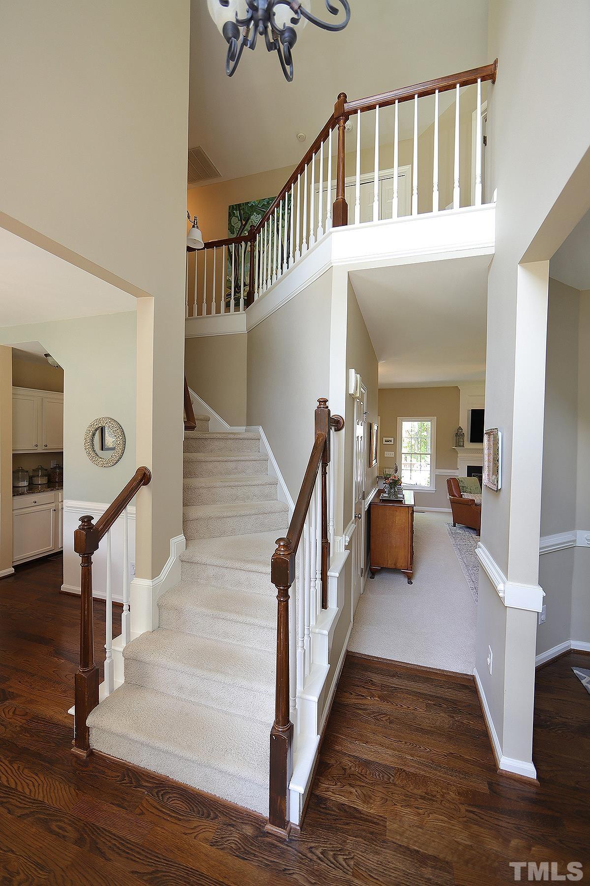 5152 Fairmead Circle Raleigh, NC 27613 - Photo 2 of 25 a view of a hallway with wooden floor and stairs