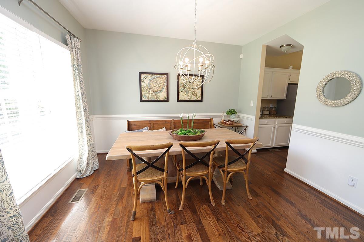 5152 Fairmead Circle Raleigh, NC 27613 - Photo 4 of 25 a view of a dining room with furniture a chandelier and wooden floor