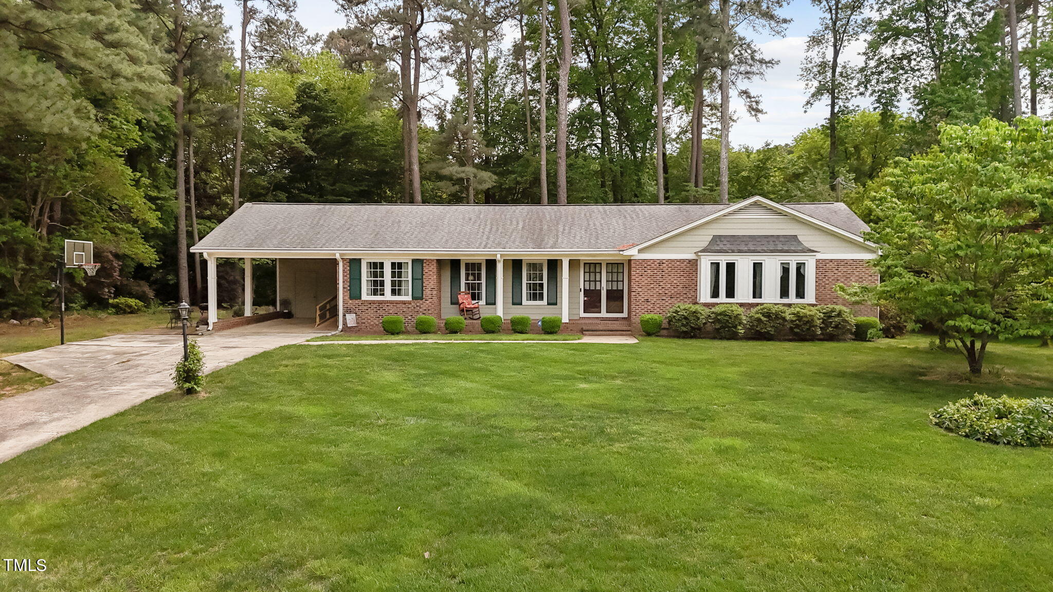 6401 Wrenwood Avenue Raleigh, NC 27607 - Photo 1 of 32 a front view of a house with a garden