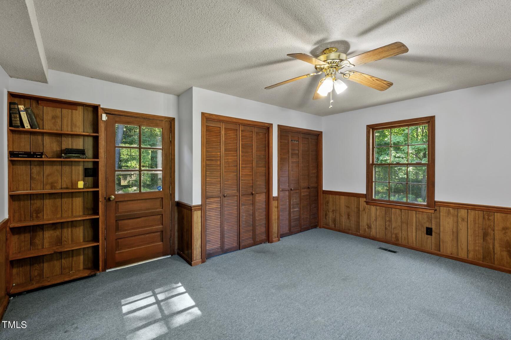 6401 Wrenwood Avenue Raleigh, NC 27607 - Photo 22 of 32 a view of an empty room with a window and a kitchen