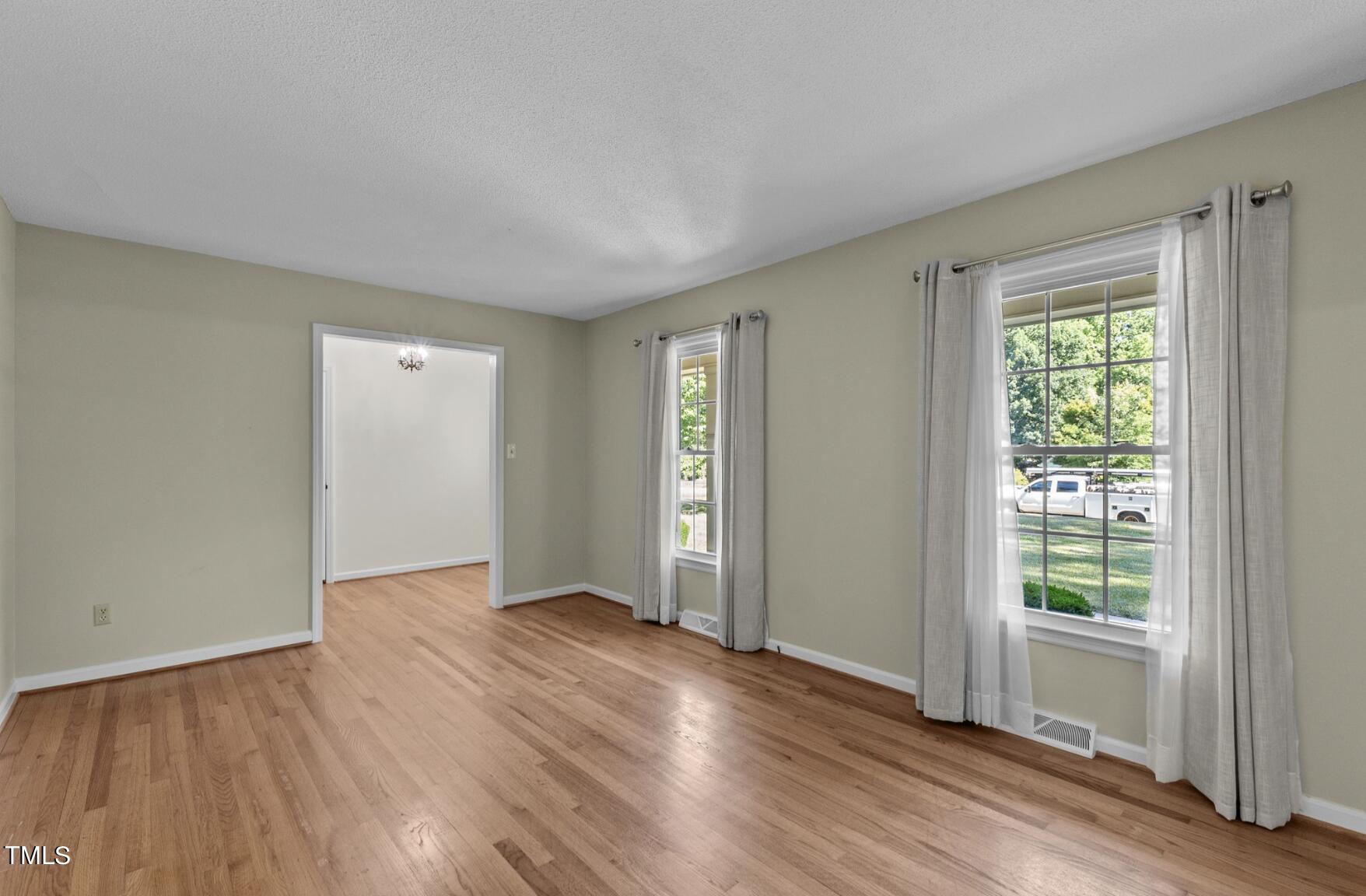 6401 Wrenwood Avenue Raleigh, NC 27607 - Photo 5 of 32 an empty room with wooden floor and windows