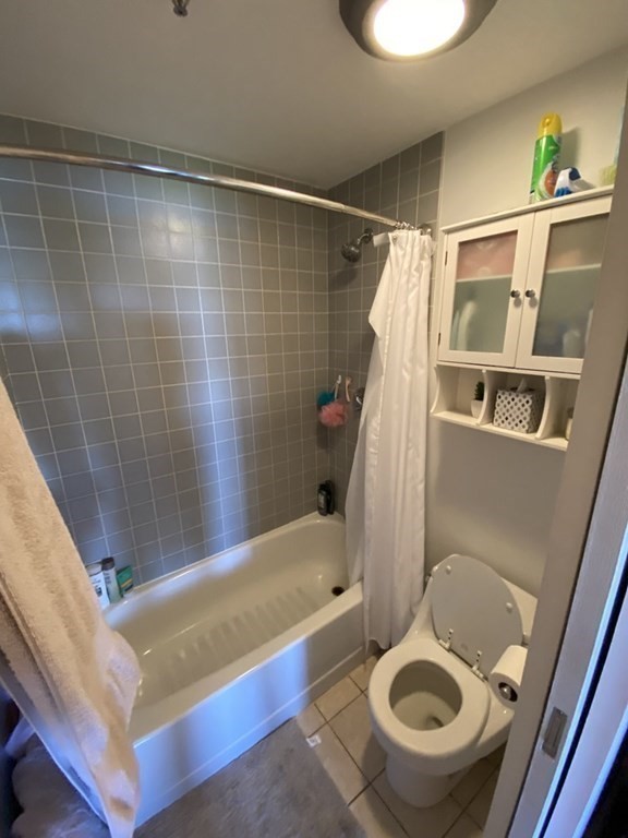 133 Commander Shea Boulevard, Unit 711 Quincy, MA 02171 - Photo 16 of 21 a bathroom with a sink and a mirror