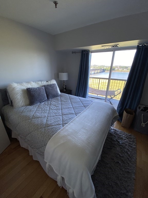 133 Commander Shea Boulevard, Unit 711 Quincy, MA 02171 - Photo 20 of 21 a bed sitting in a bedroom next to a window