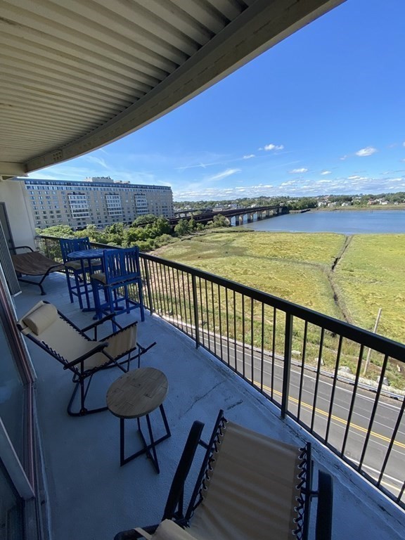 133 Commander Shea Boulevard, Unit 711 Quincy, MA 02171 - Photo 2 of 21 a view of a balcony with chairs