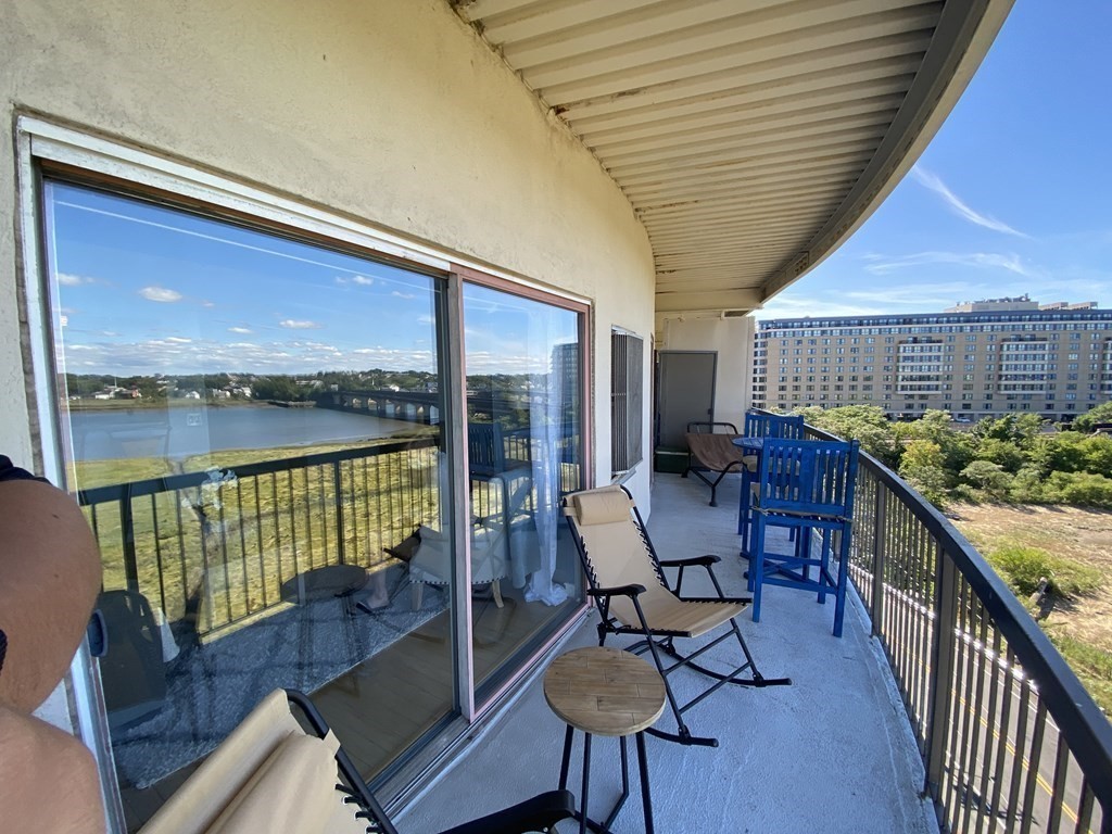 133 Commander Shea Boulevard, Unit 711 Quincy, MA 02171 - Photo 3 of 21 a balcony with chairs and wooden floor